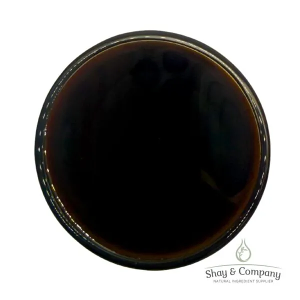 Dark brown liquid in clear container with Shay & Company natural ingredient supplier logo.