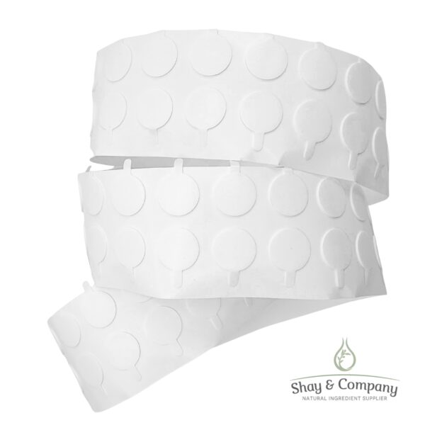 White textured wax melts or cosmetic product rolls with circular embossed pattern and Shay & Company branding.