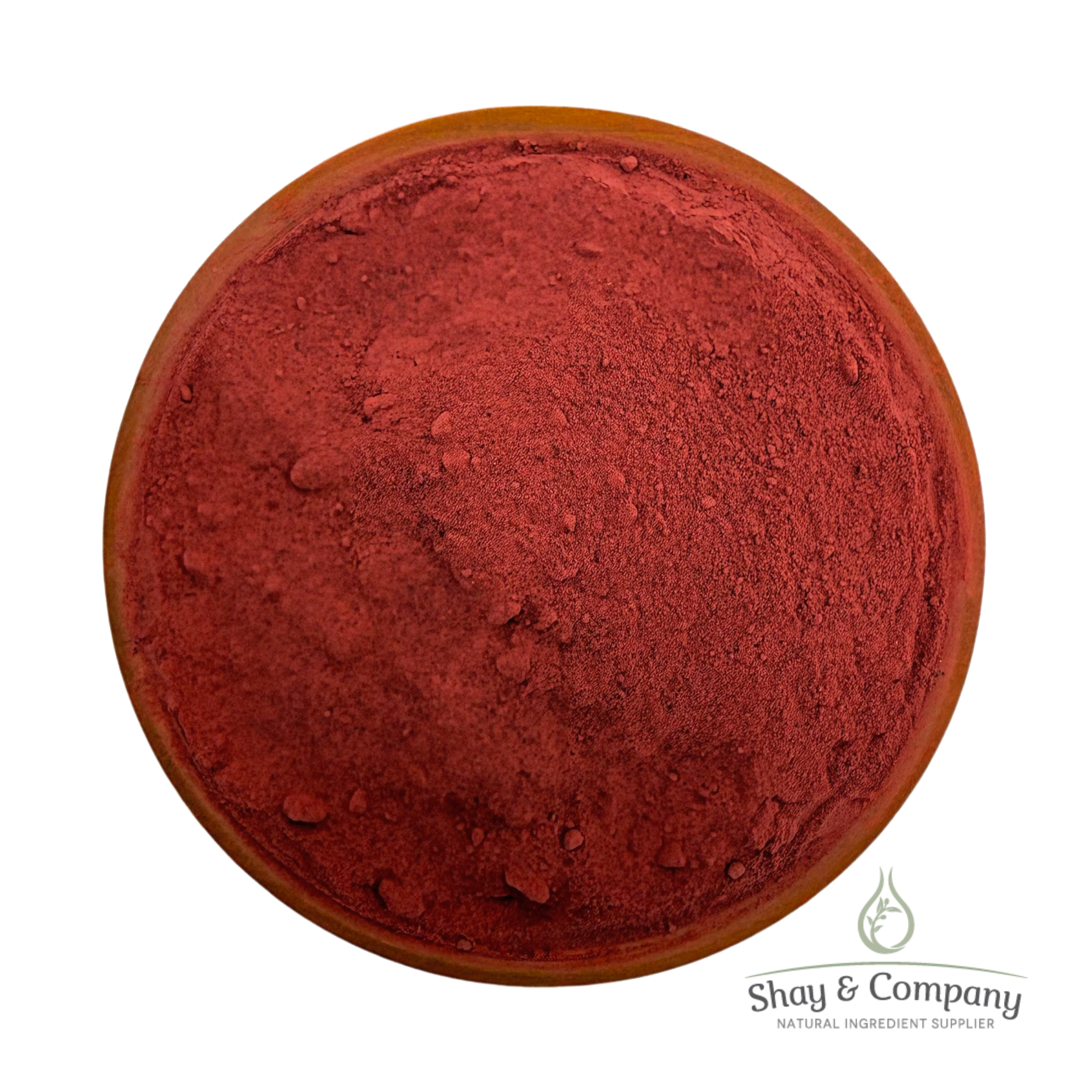 Red powder pigment in wooden bowl from Shay & Company natural ingredient supplier.