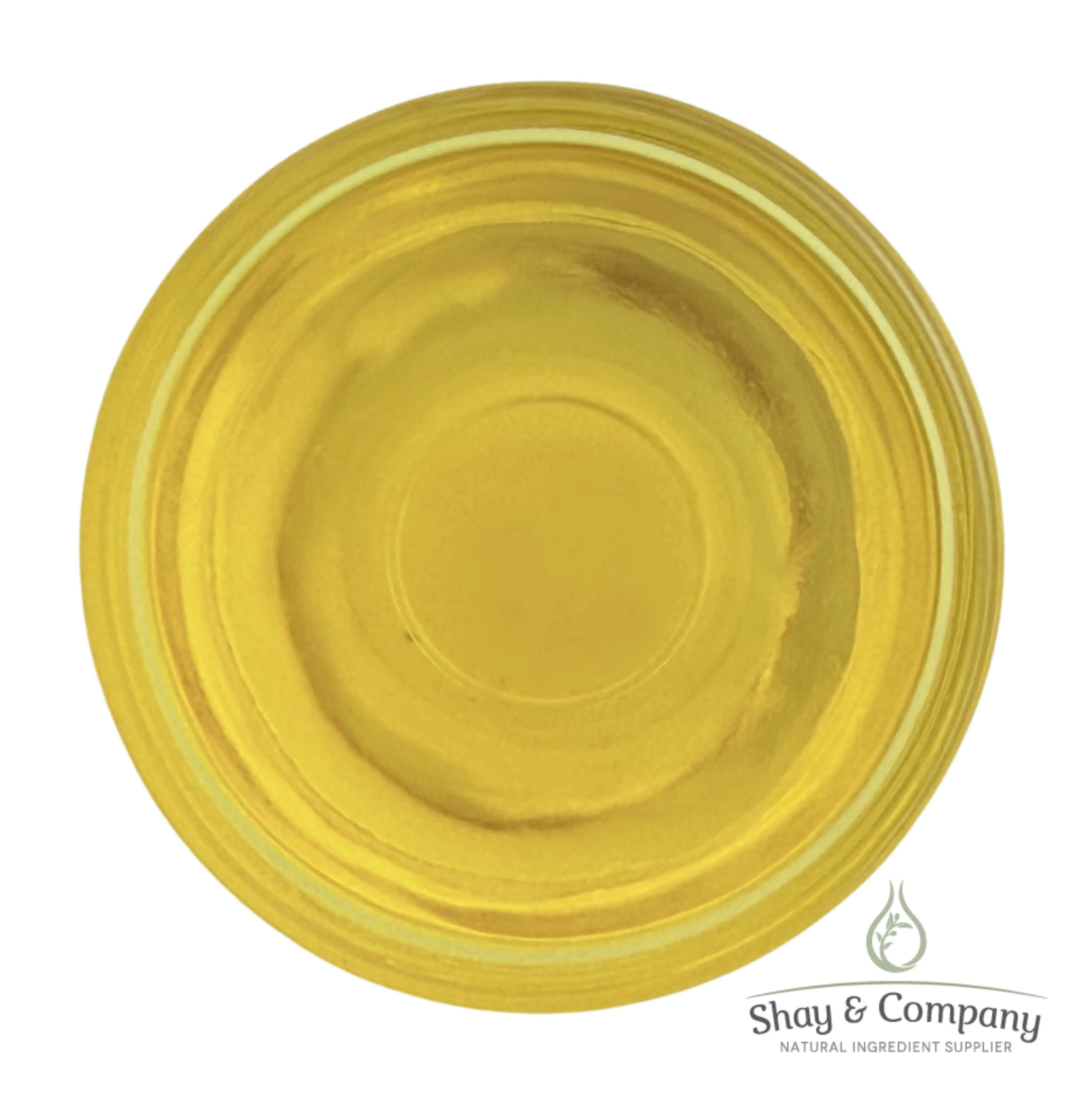 Golden yellow carrier oil in glass dish from Shay and Company.